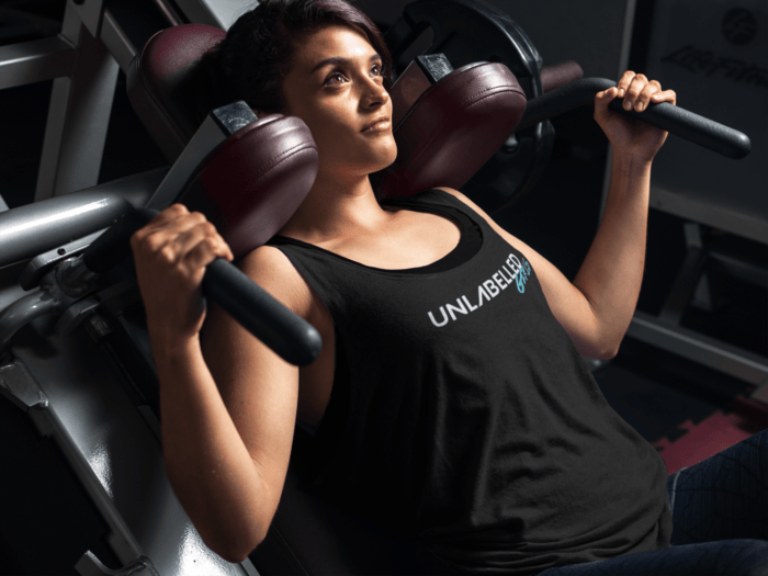 tank top mockup of a young woman exercising at the gym 7626a