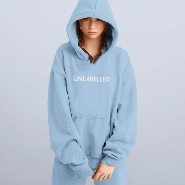 mockup of a serious looking woman wearing pullover hoodie at a studio 34076 r el2 square e1612294383474
